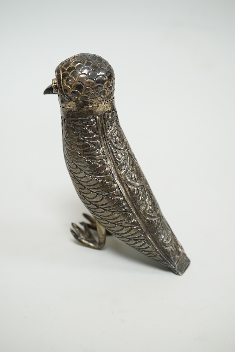 A novelty white metal pepperette, modelled as a free standing bird, with blue glass eyes, indistinct mark to one leg, height 87mm.